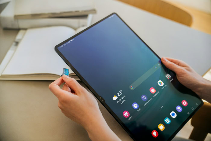 Person inserting microSD card into Samsung Galaxy tablet