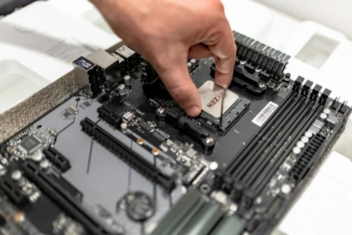 Person installing a CPU on a motherboard