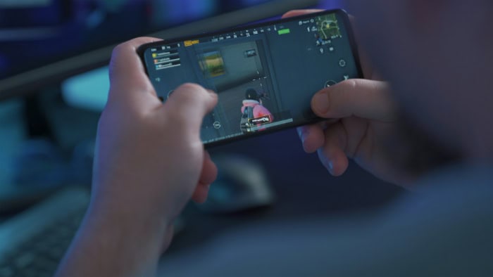 Person playing PUBG Mobile game on smartphone