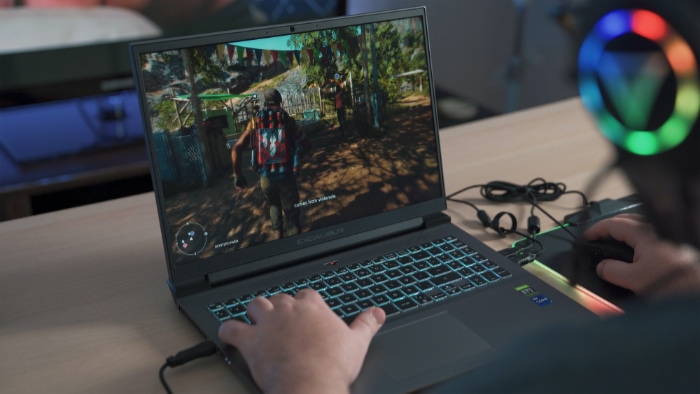 Person playing game on gaming laptop