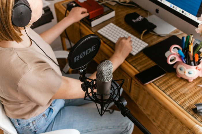 Person podcasting with RODE microphone and pop filter