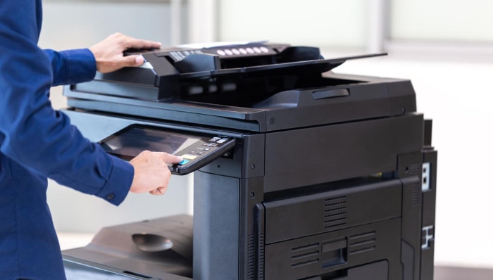 Person press button on panel of printer