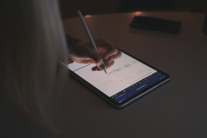 Person taking notes on iPad using Apple Pencil