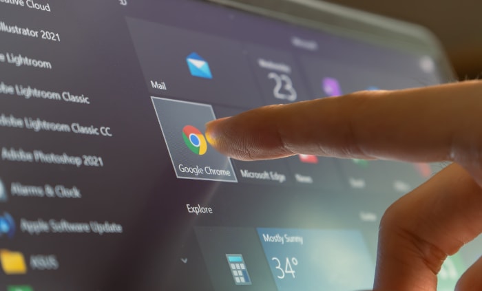 Person touching google chrome icon