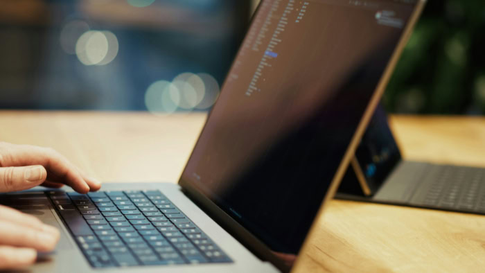 Person transferring files on laptop computer screen
