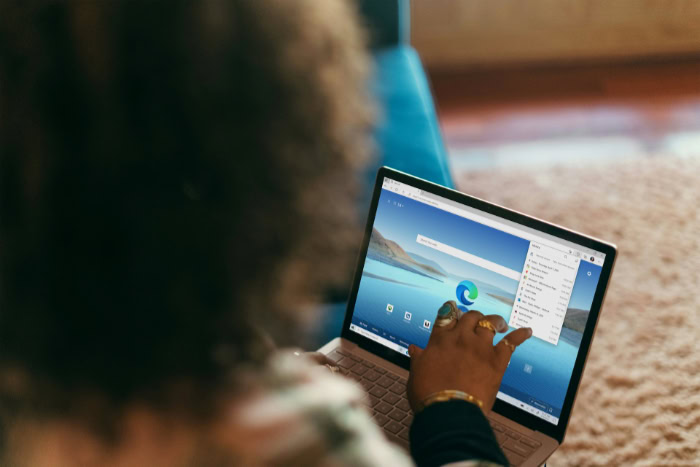 Person using Microsoft Edge browser on laptop