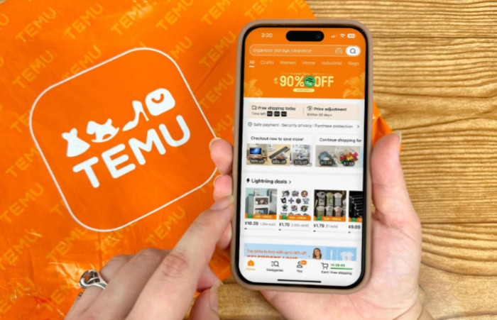 Person using Temu app on smartphone with Temu package
