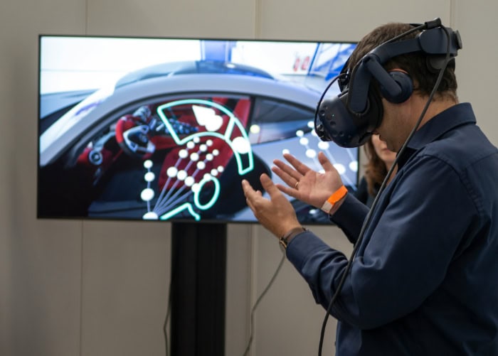 Person using VR headset to interact with design visuals