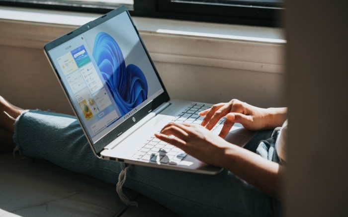 Person using Windows laptop near window