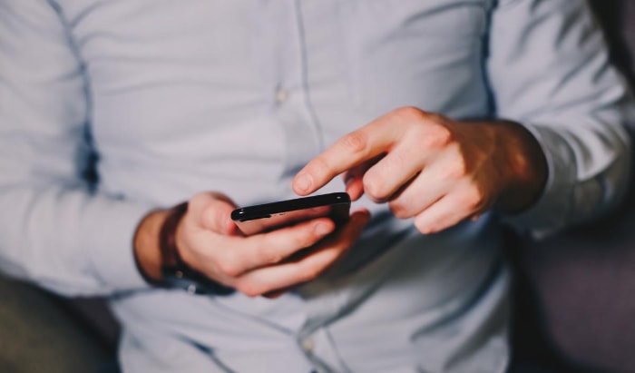 Person using black android phone