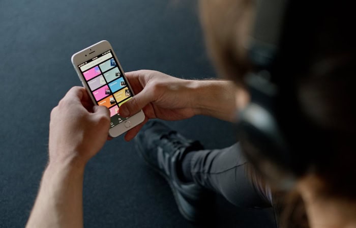 Person using colorful music app interface on smartphone