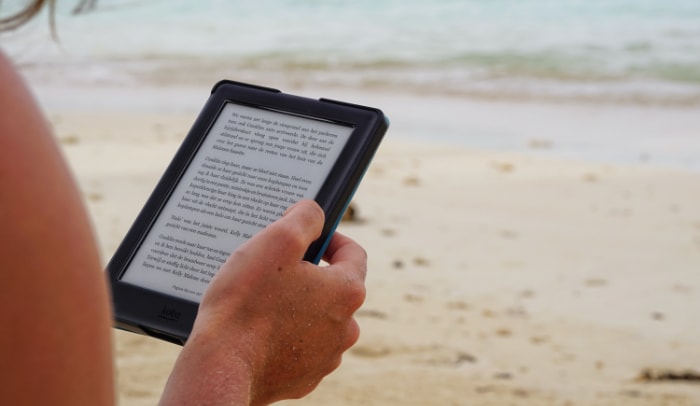 Person using kindle on beach