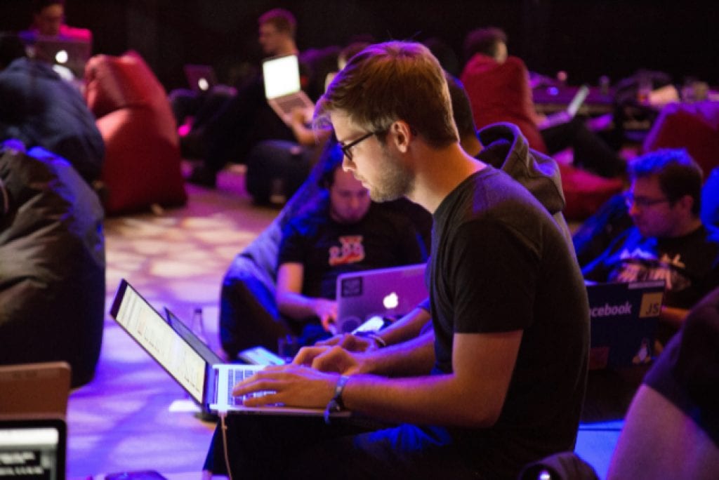 Person using laptop sitting on bean bag