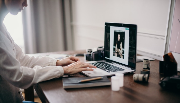 Person using laptop on desk 1