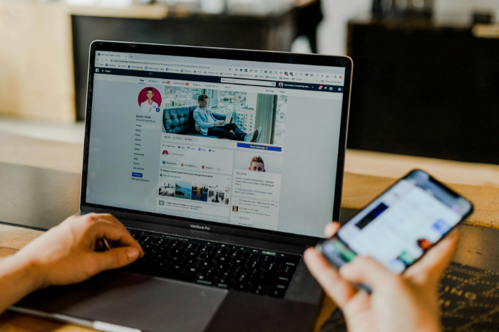 Person using laptop to browse Facebook business page