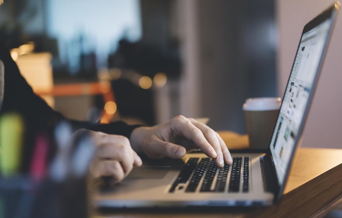 Person using macbook on desk