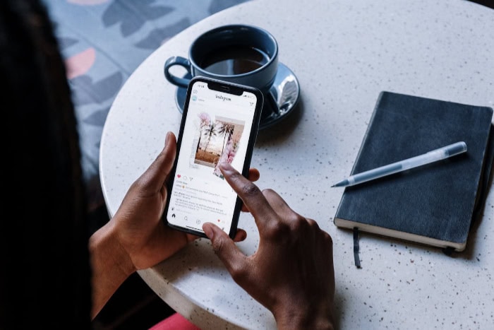 Person using smartphone at a table