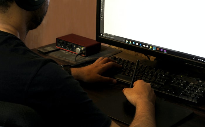 Person using stylus and computer
