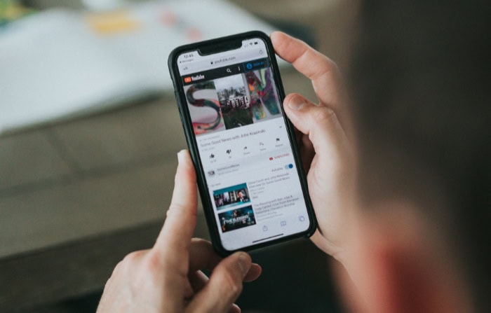 Person watching video on YouTube mobile app