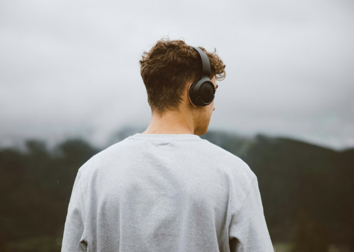 Person wearing wireless headphones outdoors