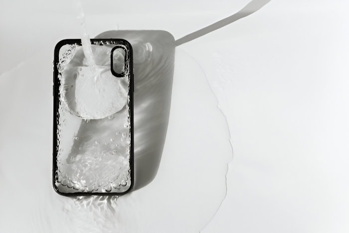 Phone case being cleaned with water