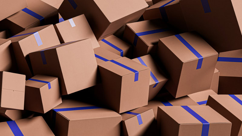 Pile of cardboard boxes sealed with blue tape