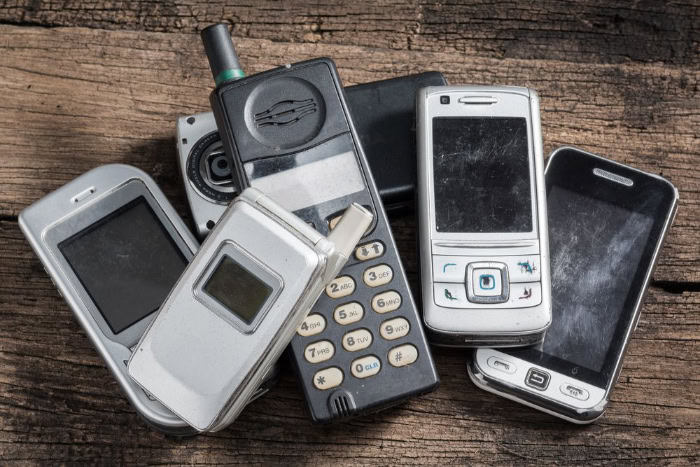 Pile of old burner and flip phones