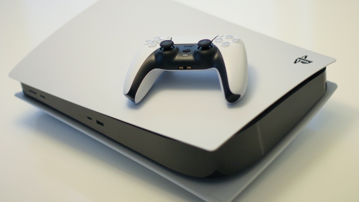 Playstation 5 with controller on white surface