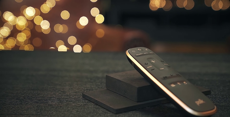 Black Polk Audio MagniFi Mini remote on black table