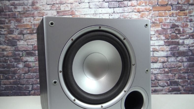 Silver Polk Audio PSW10 on white surface