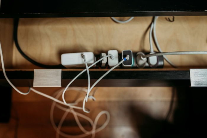 Power strip with multiple chargers under desk shelf