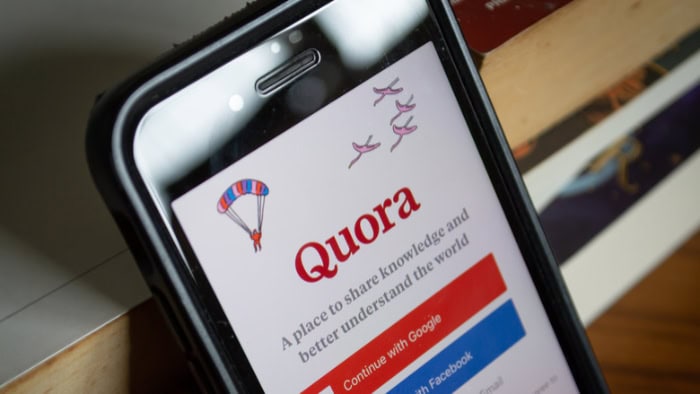 Quora app login screen on smartphone with parachute logo