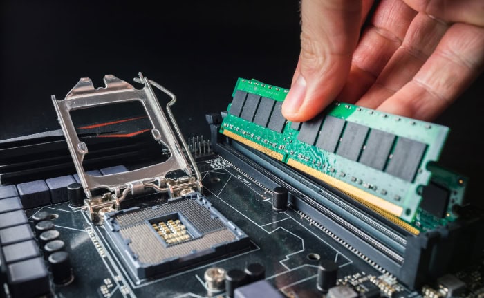 RAM module being inserted into computer motherboard slot