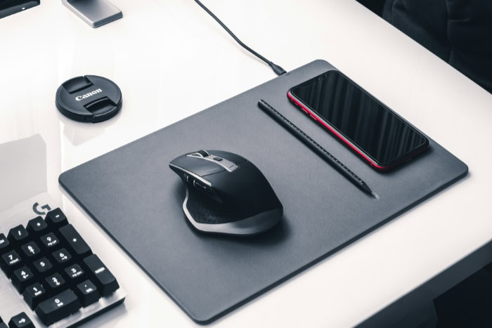 Rapoo wireless ergonomic mouse on grey desk mat
