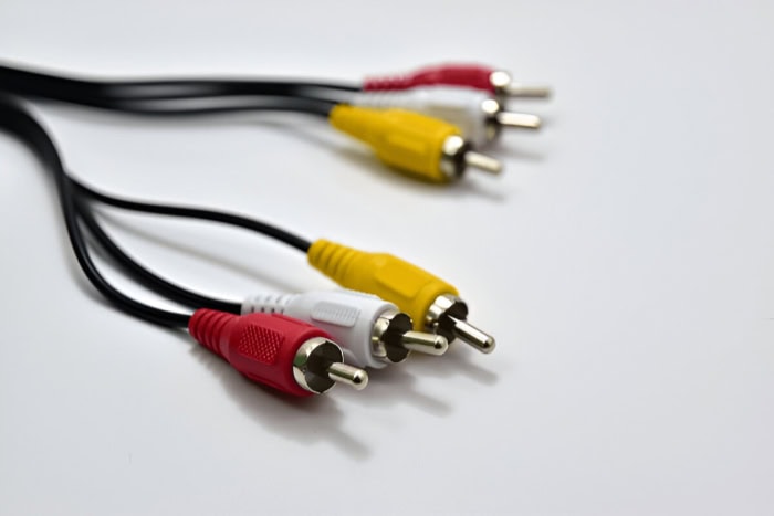 Red white and yellow RCA cables on white background