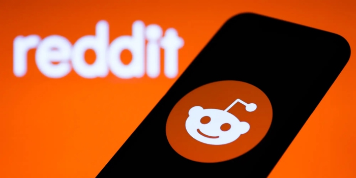 Reddit logo on smartphone and background