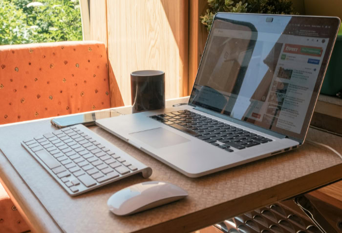 Remote work laptop setup on small indoor desk