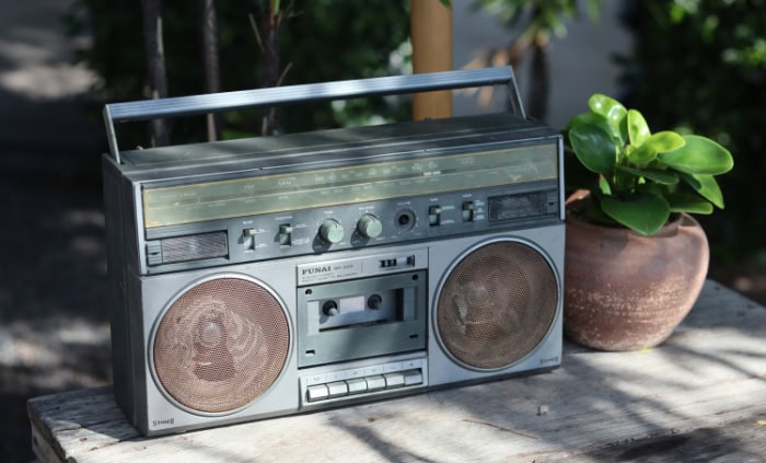 Retro radio cassette player on wooden table