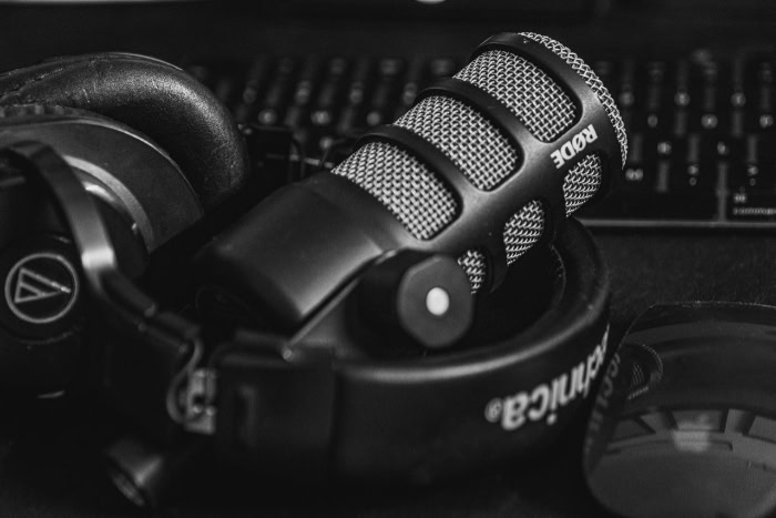 Rode microphone and Audio Technica headphones on desk