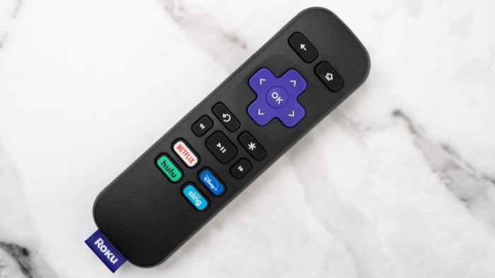Roku remote control on a marble surface