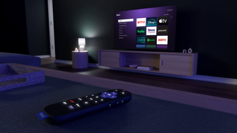 Roku remote on table with TV in background