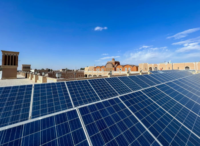 Rooftop solar panels with Middle Eastern cityscape background