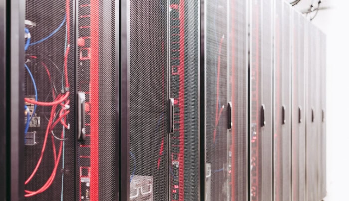 Row of server racks with mesh doors in data center