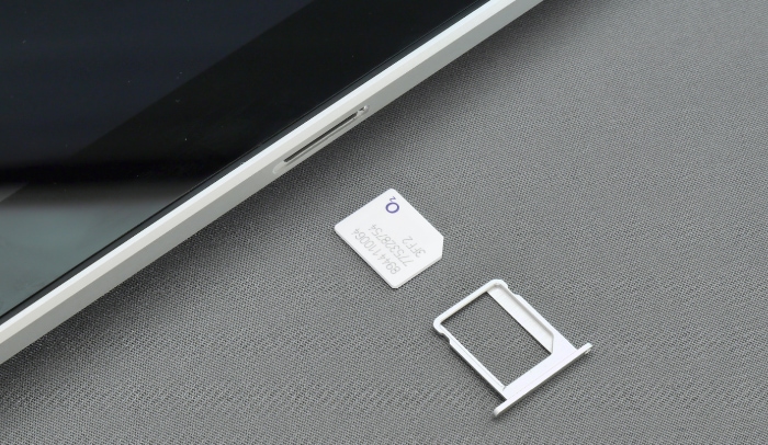 White SIM card between SIM card tray and iPad