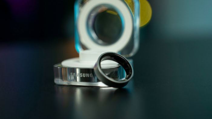 Samsung smart ring and charging case on table