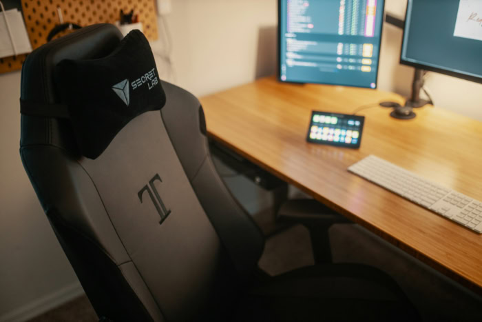 Secretlab TITAN gaming chair beside a dual monitor desk setup