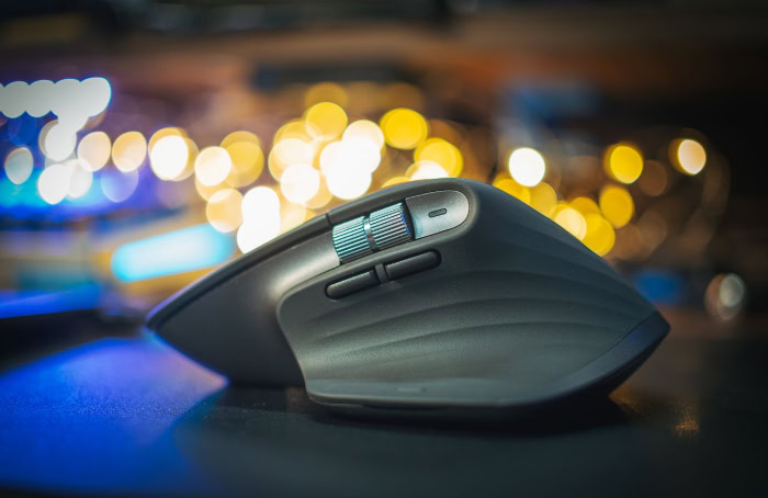 Side profile of ergonomic wireless mouse with bokeh background
