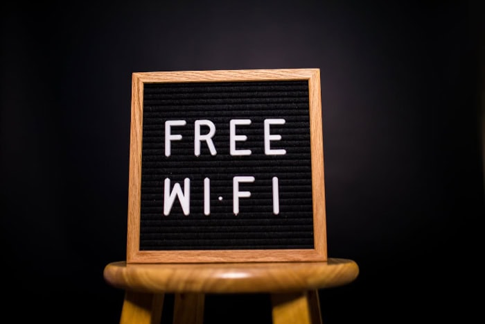 Sign displaying Free Wi Fi on a wooden stool