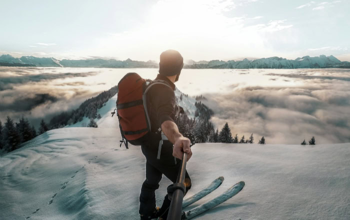 Skier takes selfie on snowy mountain with GoPro camera