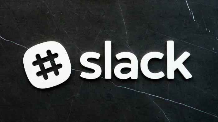 Slack logo on dark stone background